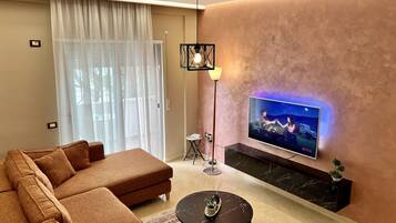Deluxe Apartment | Living area | 55-inch LED TV with satellite channels, TV, Netflix