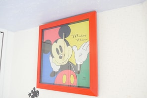 A framed Mickey Mouse artwork on a wall.