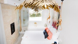 A modern bedroom with a wooden bed, a small bedside table, a window with a view, and a shower area. - Romantic loft for couples with views of the ocean, the salt flats, and the natural park (Calpe)