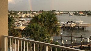A marina with boats docked, a rainbow in the background, and houses along the water. - Great 3Br/2Ba Waterfront Condo in OBA near Perdido Pass (Orange Beach)