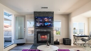 A modern living room with a fireplace, a mounted TV, and a comfortable seating area. - 1stResorts.com 3NEW FAMILY VILLAS/AMAZING WATER VIEWS/AC/3 decks/3hottubs/parkng (San Diego)