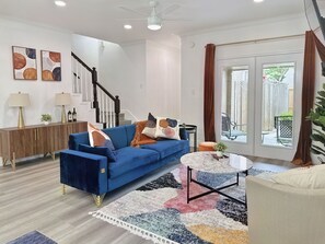 Relax in this stylish living room with a sofa, console table, and round coffee table.
