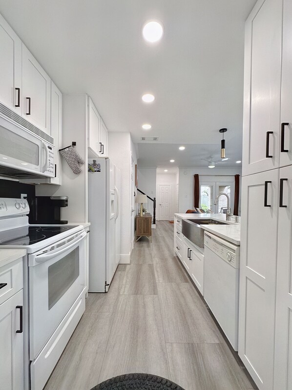 Enjoy cooking in this well-equipped kitchen with microwave, oven, and dishwasher.