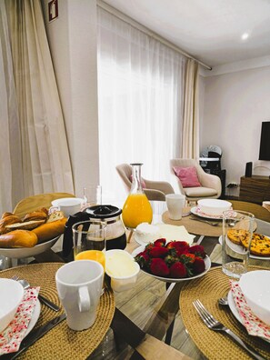 A breakfast setting with croissants, strawberries, and a coffee pot. - Coastal Escape •Steps to Beach •Pool • Inema Lagos (Lagos)