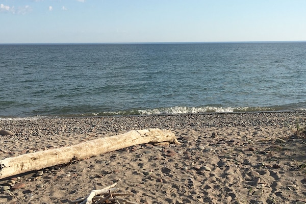 Ranta lähistöllä, aurinkotuoleja, rantapyyhkeitä