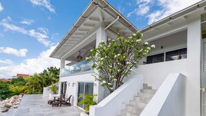 A modern two-story house with a balcony, a staircase, and outdoor seating. - Sugarbird Villa - Estate Coral (Rif. St. Marie)