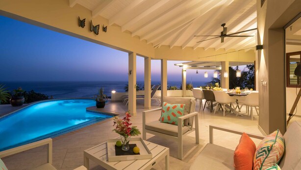 A covered outdoor area with a pool, seating, and a view of the ocean. - Villa Vila Blenchi - Coral Estate (Rif. St. Marie)