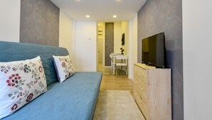 A bedroom with a bed, a TV, a desk, and a chair. - Cosy flat in Dob street, Juliet (Budapest)