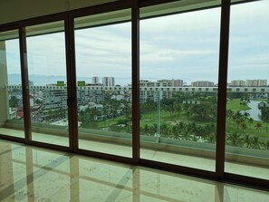 Enjoy a panoramic view of the coastal city from the large floor-to-ceiling window.