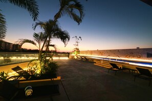 Relax on the rooftop terrace with lounge chairs and a serene view of the sky.