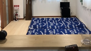 A room with a bed, a television, a fire extinguisher, and a window with curtains. - Kanazawa-Hachitabi Konjiki (Kanazawa)