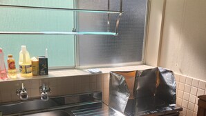 A kitchen with a sink, countertop, window, and a fan. - Kanazawa-Hachitabi Sennichi (Kanazawa)