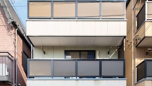 A multi-story residential building with a flat roof, a garage, and a balcony. - Z&Z Inn Honjo- Azumabashi (Tokyo)