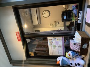 A reception area with a clock, a 'Welcome' sign, and a display of plush toys. - GH One More Heart Kyoto Station South 4 (Kyoto)