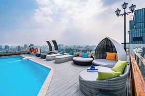A rooftop pool area with lounge seating and a city view. - Saigon Finest - IDG Suites Collection - 12J (Ho Chi Minh City)