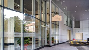 A modern building with large glass windows, a sign for the 1960 Presidential Club, and potted plants outside. - Saigon Skyline Suite in Central District 1 (Ho Chi Minh City)