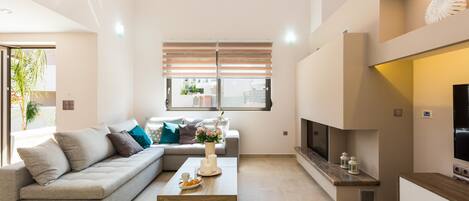 A modern living room with a sofa, coffee table, and TV.