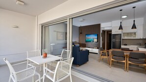 A modern apartment with a dining area, kitchen, and living space. - Thalita Cozy Apartment (Heraklion)