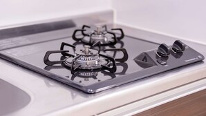 A gas stove with four burners and a control panel. - Sunshine Tower 202 (Tokyo)