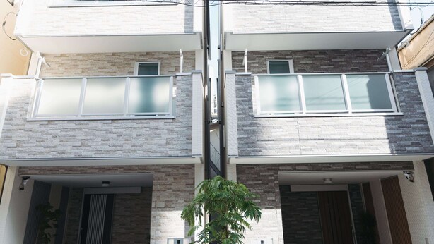A modern two-story residential building with a symmetrical facade, large windows, and a central entrance with a decorative white fence. - Back to 90s American Style House (Tokyo)