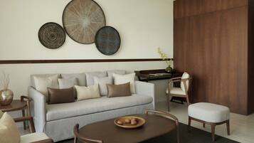 A modern living room with a grey sofa, wooden coffee table, and a dining area with a wooden table and chairs.