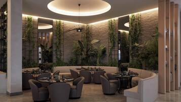 A modern interior with a circular seating area, a central light fixture, and vertical greenery on the walls.
