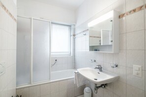 Bathtub, hair dryer, bidet, towels