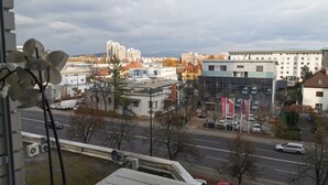 A cityscape with modern buildings, a road, and a clear sky. - Dunajska Apartment (Ljubljana)