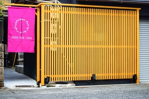 A charming entrance with a decorative banner and a traditional wooden gate.