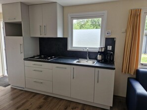 Fridge, stovetop, dishwasher, coffee/tea maker