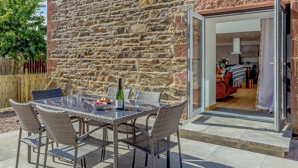 A stone building with a glass door leading to an interior space. - 3 bedroom accommodation in Woodhead, near Turriff (Woodhead, near Turriff)