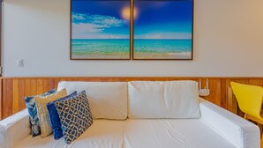 A room with a bed, a wooden headboard, and a yellow chair.