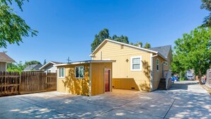 A two-story house with a garage, a small attached structure, and a fenced backyard. - @ Marbella Lane - MiniGuest House | DTWN SJ | Parking (San Jose)