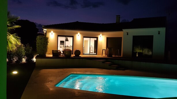 A modern house with a swimming pool at dusk. - Magnificent villa with private pool (Mirepeisset)