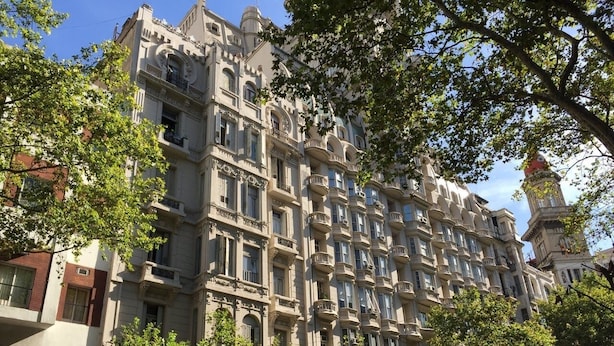 A multi-story building with ornate architectural details, including balconies and decorative moldings. - Avenida Tango (Buenos Aires)