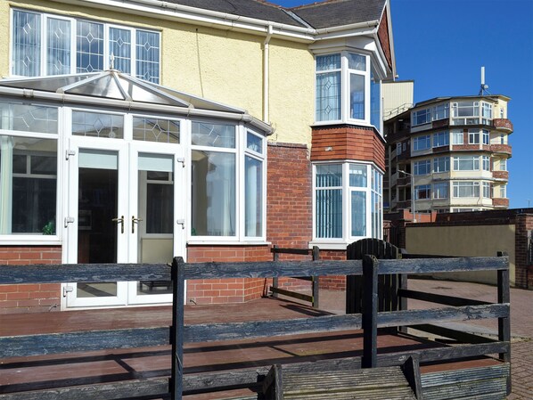 A building with a bay window, a conservatory, and a corner bay window.