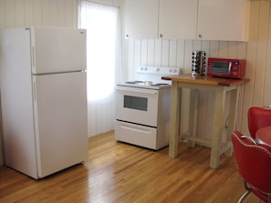 Enjoy cooking in this fully equipped kitchen with a refrigerator, stove, and microwave.