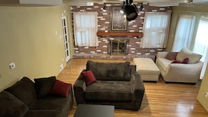 A living room with two sofas, a coffee table, and a fireplace. - Secluded, Charming and Unique!  Spacious Apartment EXCELLENT Central Location (San Diego)