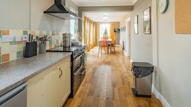 A kitchen with a stove, oven, and a trash bin. - 3 bedroom accommodation in Thornholme, near Driffield (Thornholme, near Driffield)