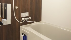 A modern bathroom with a wooden wall, a white bathtub, and a showerhead. - Sakura34 (Sapporo)
