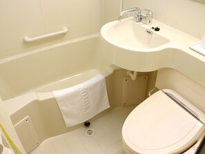 A bathroom with a bathtub, sink, and toilet.