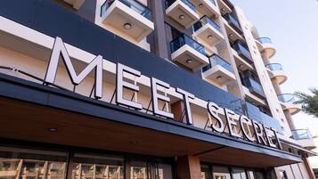 A building with the sign "MEET SECRET" indicating a business or service establishment.