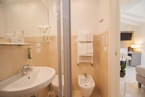 A modern bathroom with a sink, bidet, and towel rack. - Leone (Venice)