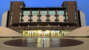 A modern building with a large entrance and a central atrium. - Sazanka (Okinawa)
