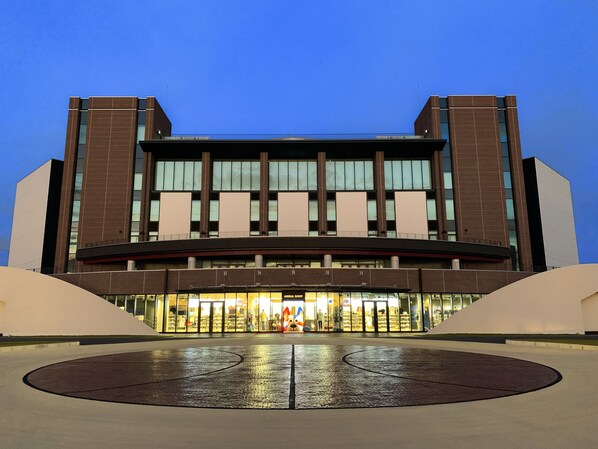 A modern building with a large entrance and a central atrium. - Sazanka (Okinawa)