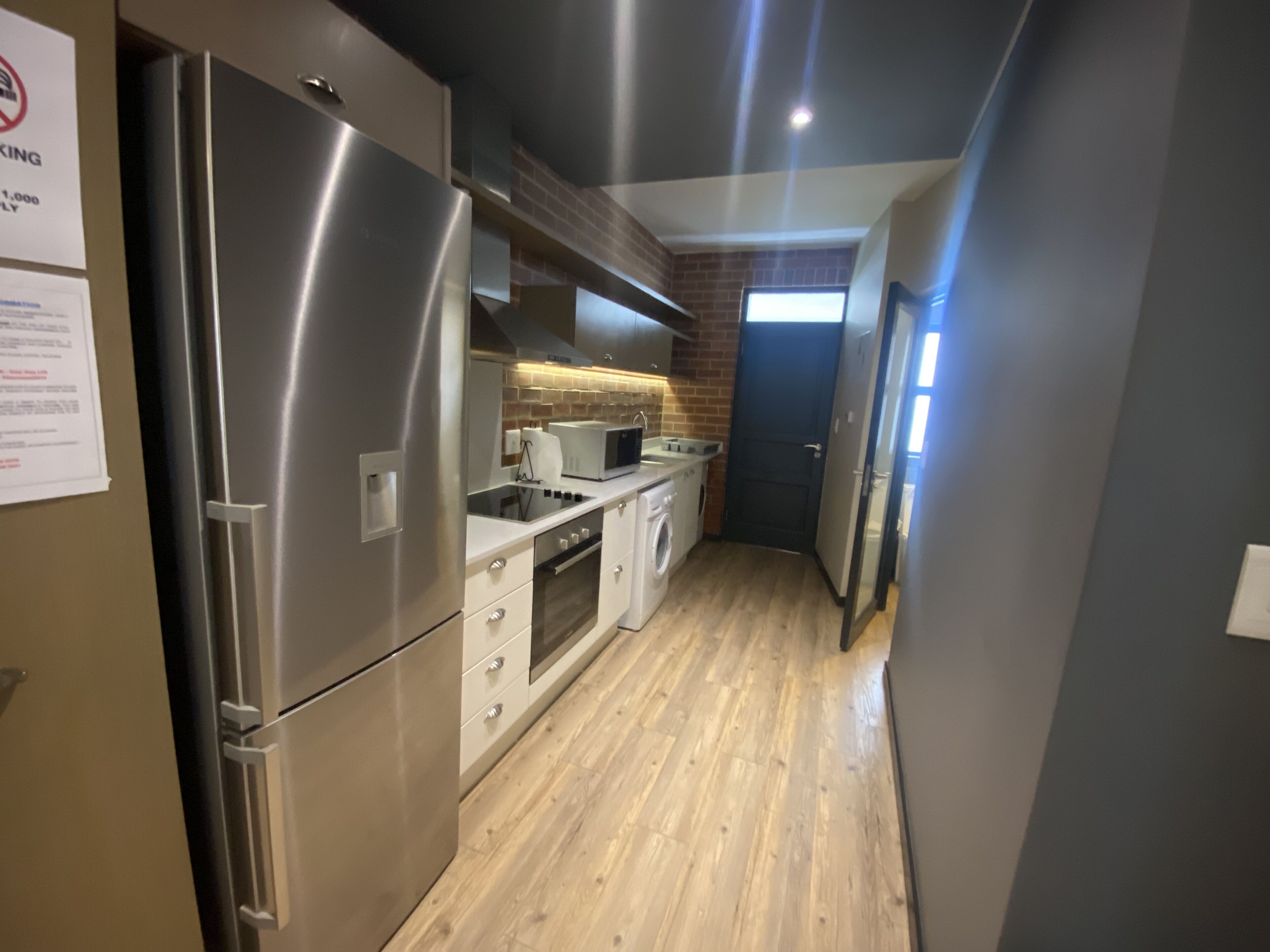 A modern kitchen with stainless steel appliances, a microwave, and a built-in oven.