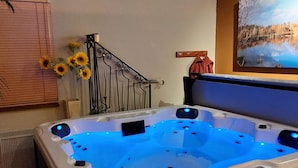 A hot tub with a blue light, a painting of a lake, and a metal staircase. - Spacious Holiday Home in Rekken With Hot Tub (Rekken)