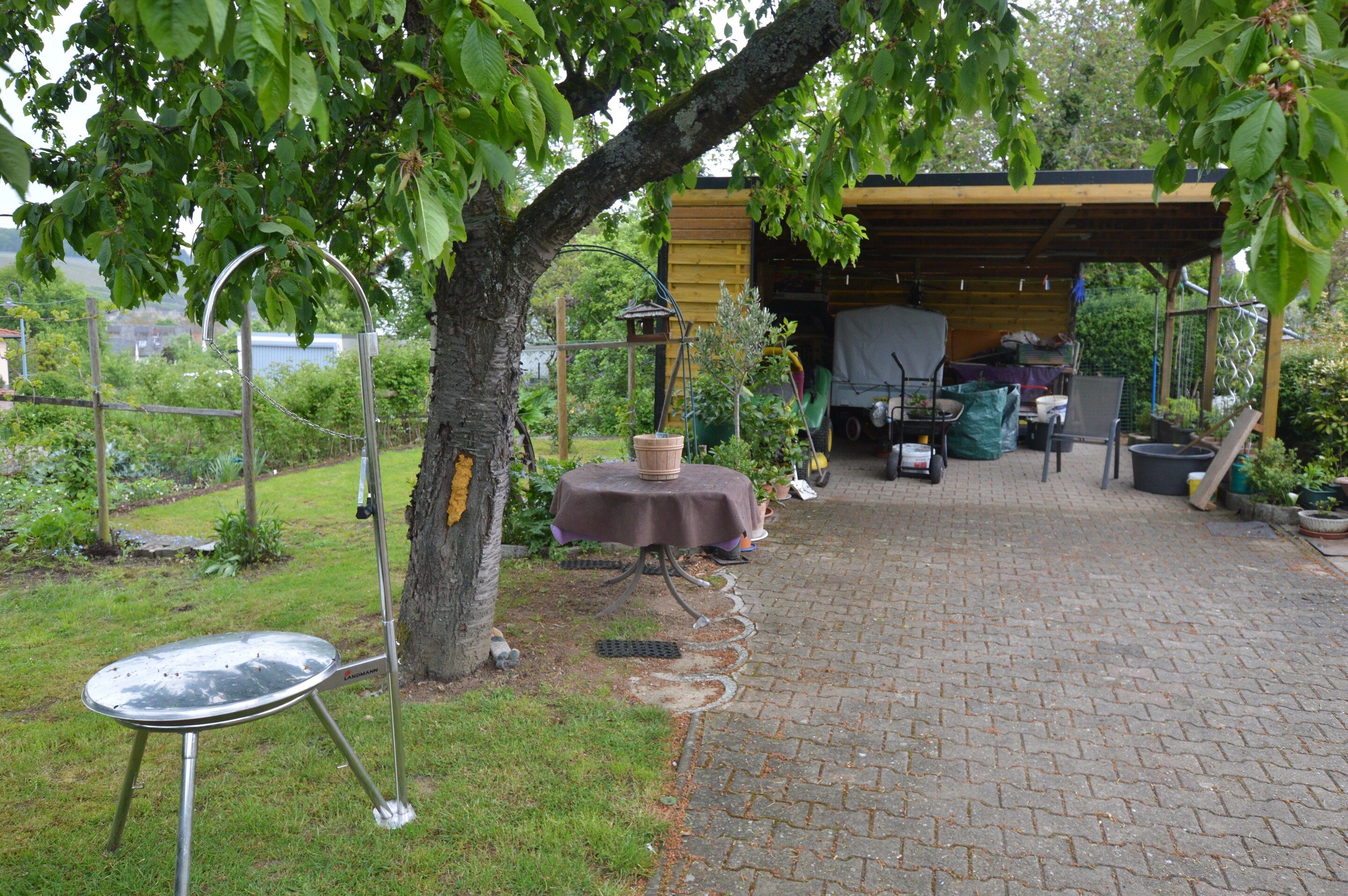 Ulkoterassi, jossa on pöytä, tuoleja ja pergola.