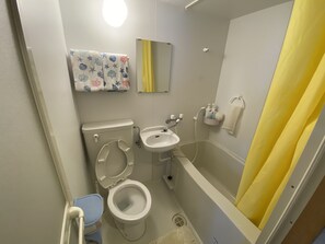 A bathroom with a toilet, sink, and bathtub. - Beach House 1 & Private Beach (Onna)