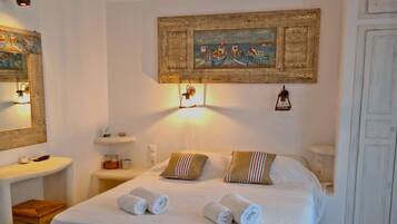 Cozy retreat with a single bed, bedside table, and nautical-themed decor.